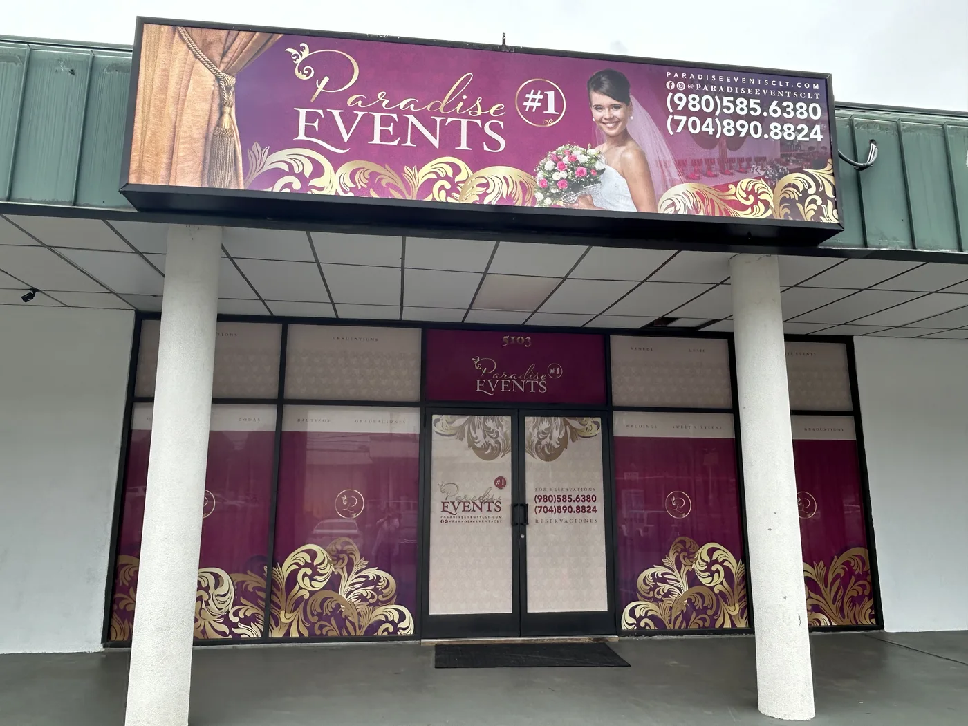Paradise Events venue after the redesign: a lit sign with the logo and a bride, and purple and gold graphics on every window and door.